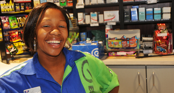 Smiling cashier at a grocery store.