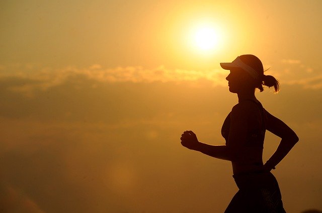 Woman running at sunset