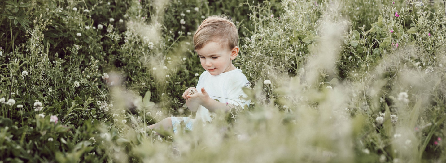 Child in a field of green.