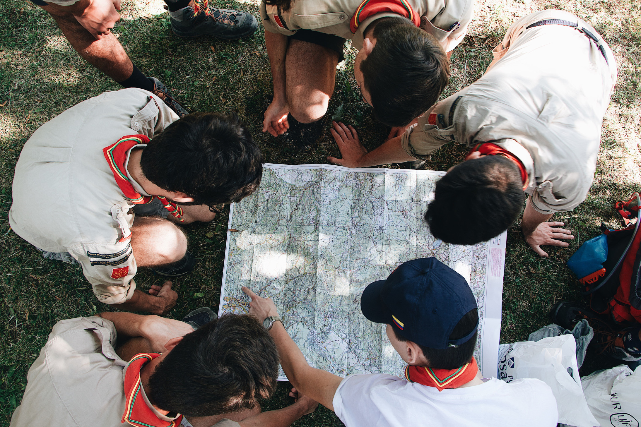 A group of scouts pores over a map.